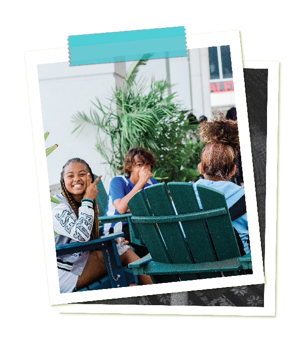 Kids having fun with each other while sitting in chairs